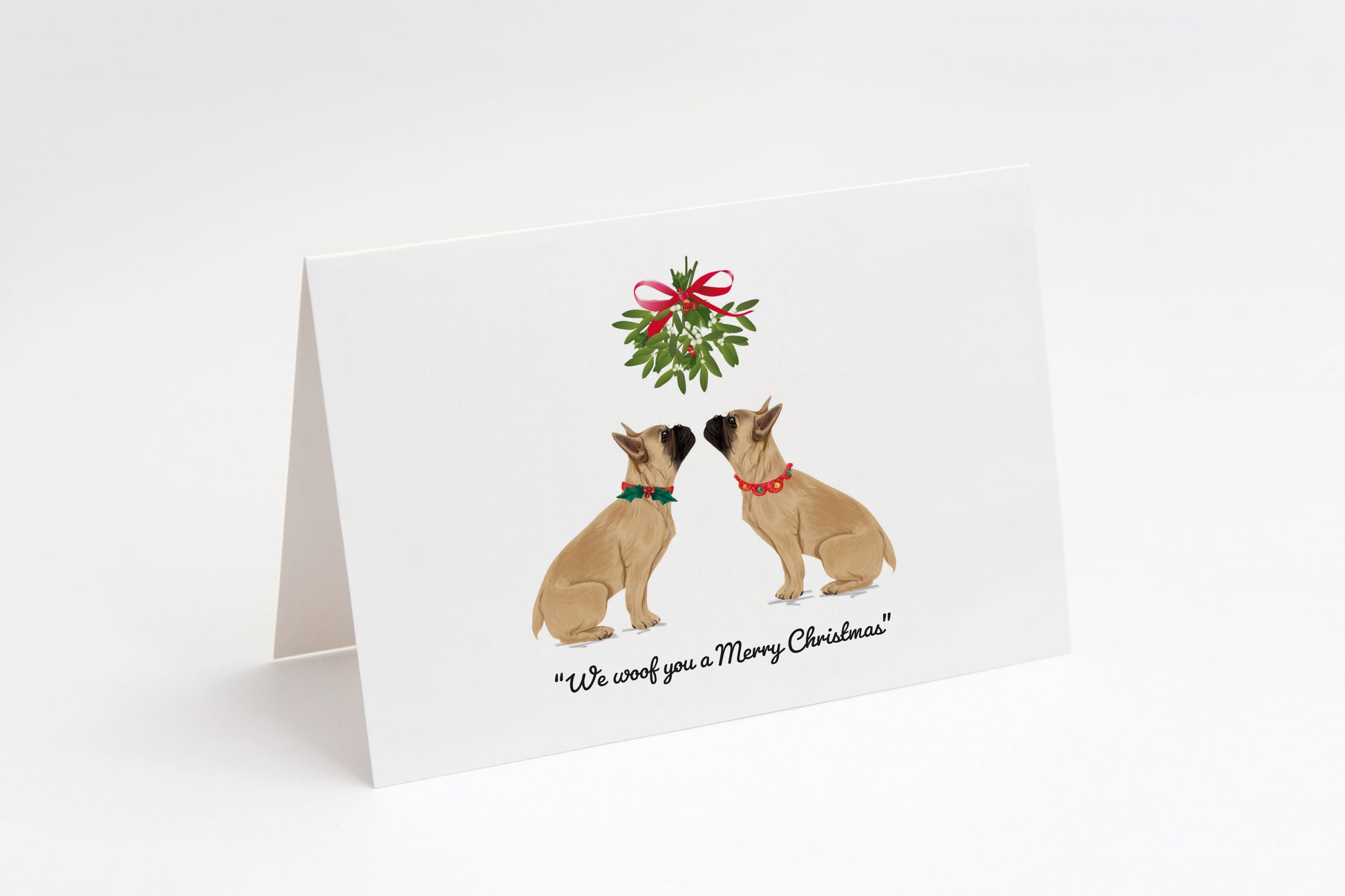 Christmas card with two cream French Bulldogs and a wreath on a white background. "We woof you a Merry Christmas!" text underneath.